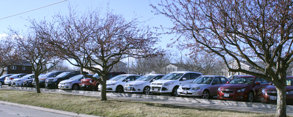 Cars parked in a parking lot on campus.